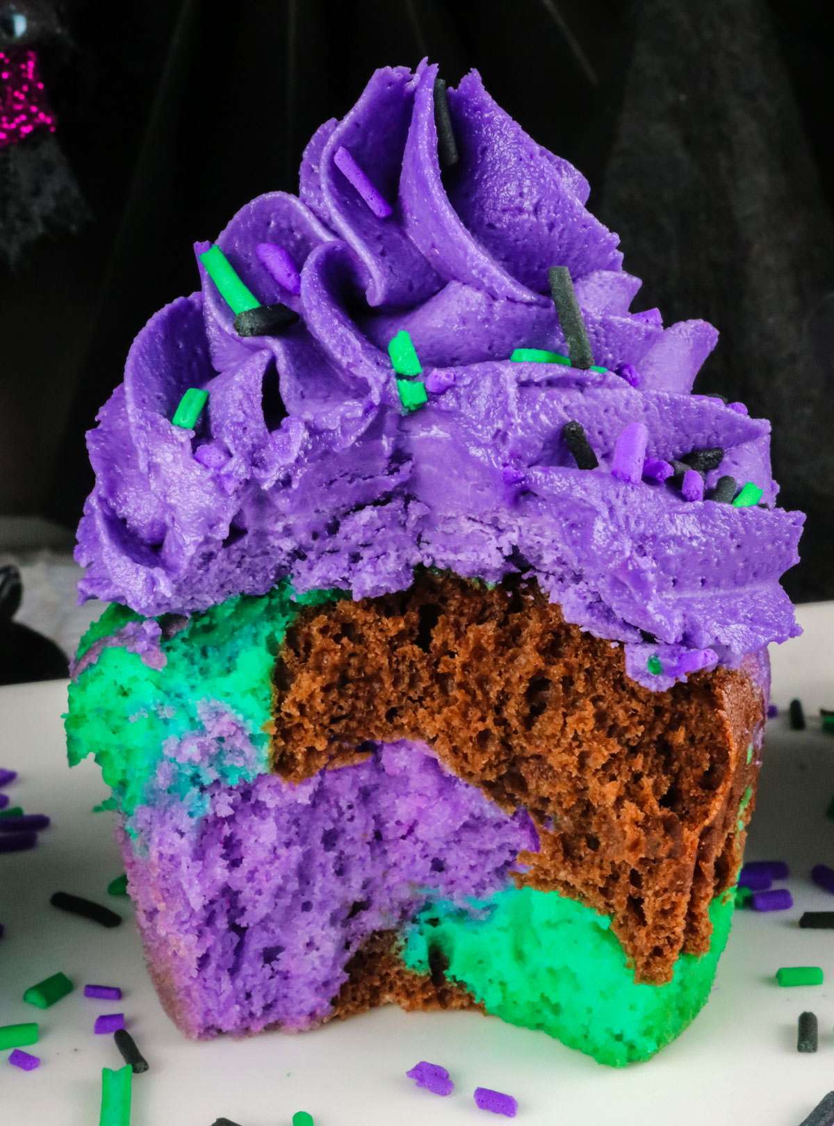 Closeup of a Bewitched Marble Cupcake, cut in half to show the marbling effect inside.