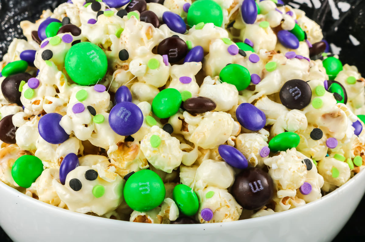 Closeup on a white serving bowl filled with Bewitched Halloween Popcorn.