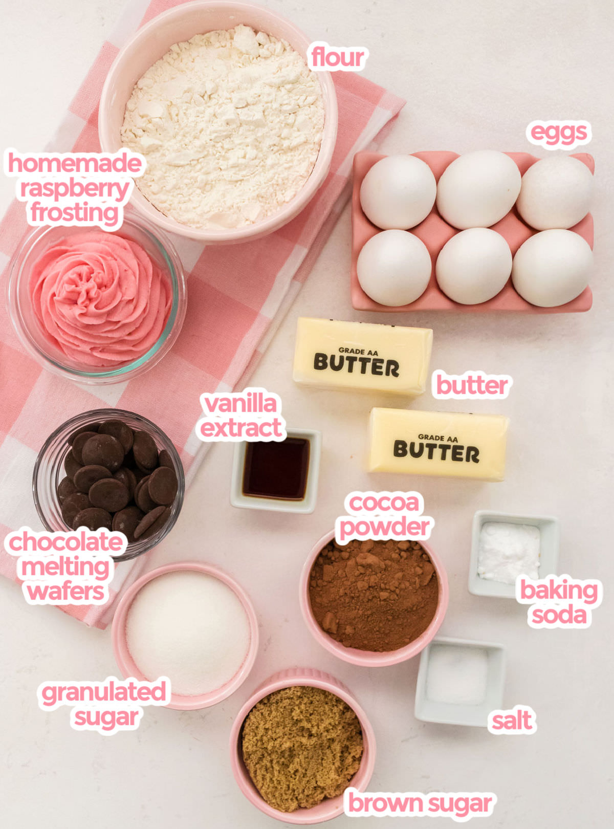 All the ingredients you will need to make Chocolate Cookies including Flour, Eggs, Raspberry Frosting,  Butter, Vanilla, Chocolate Wafers, Cocoa Powder, Granulated Sugar and Brown Sugar.