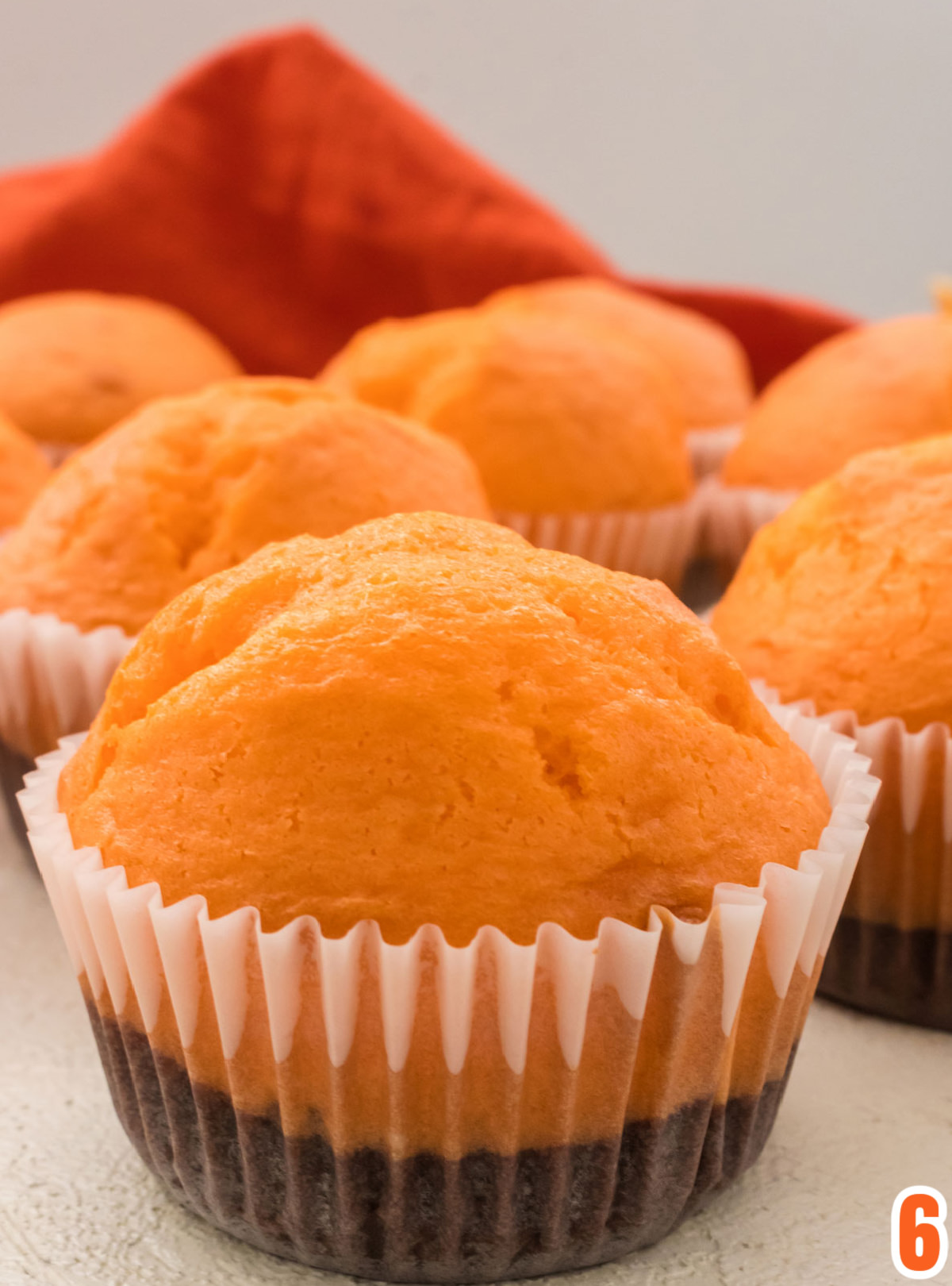 Closeup on the Brownie Cupcakes out of the oven, cooling on a white surface.