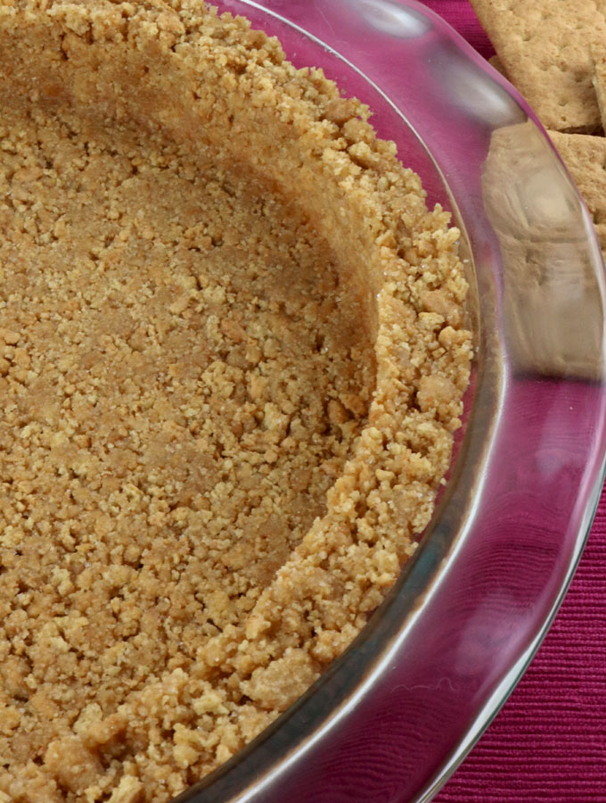 We show you How to Make Graham Cracker Crusts that are super easy to make, can be bake or no-bake and taste better than anything you can buy in the store. This is the Best Graham Cracker Crust recipe that you are going to find. Pin this Perfect Graham Cracker Crust recipe for later and follow us for more pie crust recipe ideas.