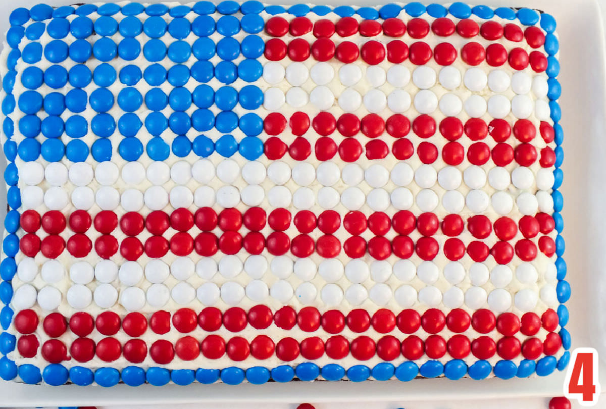 Close up of a cake decorated with Red White and Blue M&M's to make an American Flag.