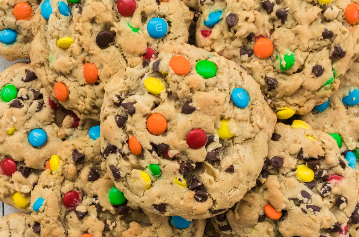 Close up on a stack of Monster Cookies on a white surface.