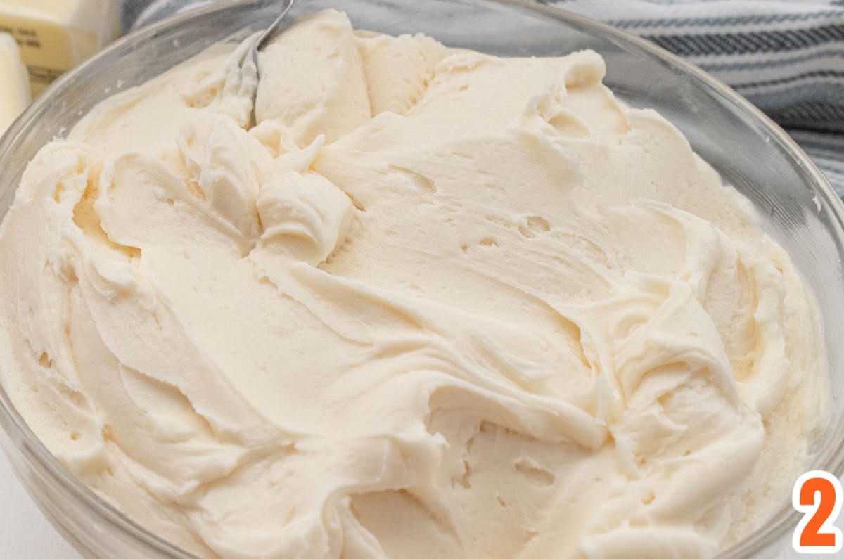 Closeup on a clear glass bowl filled with Homemade Buttercream Frosting.