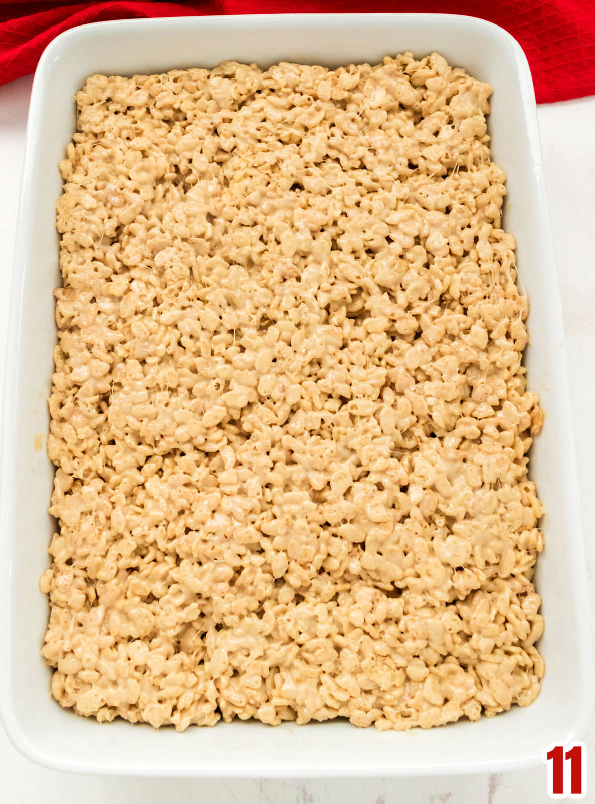 Overhead shot of the Salted Caramel Rice Krispie Treat mixture pressed down into a 9x13" pan.