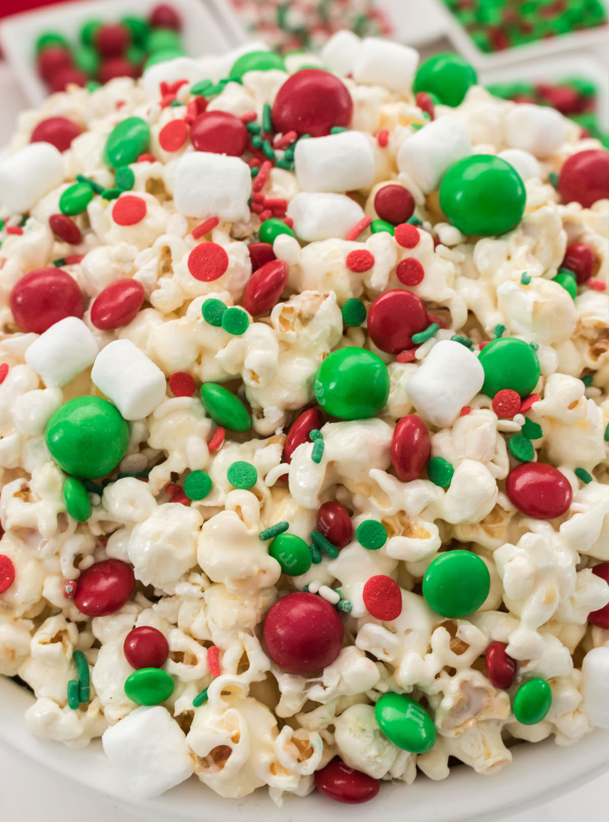 Closeup on a white serving bowl filled with Santa Crunch Popcorn.