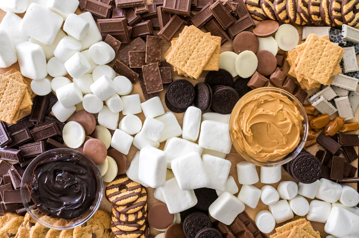 Overhead shot of the S'mores Dessert Board featuring marshmallows, cookies, chocolate and other ingredients.