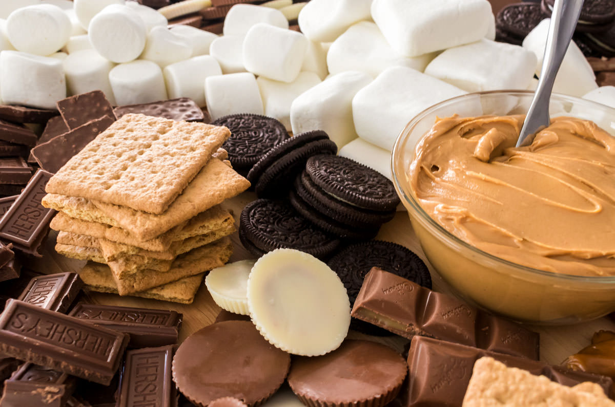 Closeup of a S'mores Dessert Board featuring marshmallows, cookies, chocolate and peanut butter.
