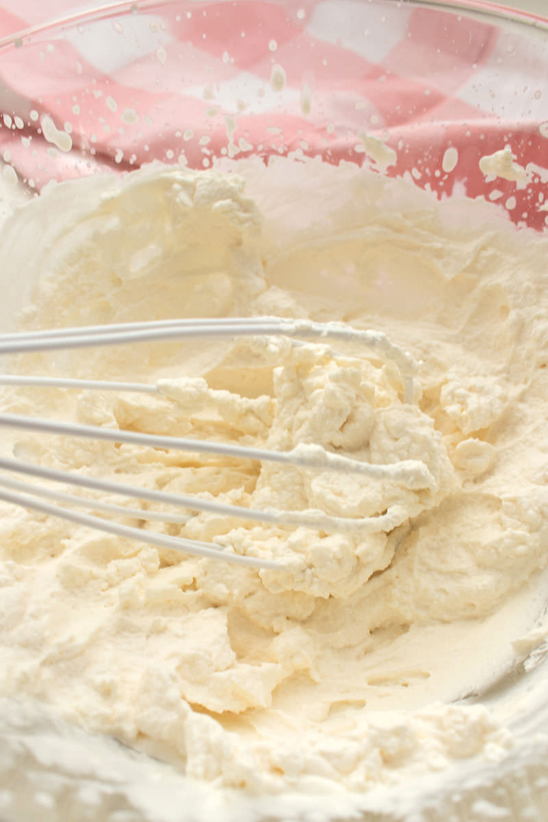 a clear bowl filled with the best ever homemade whipped cream