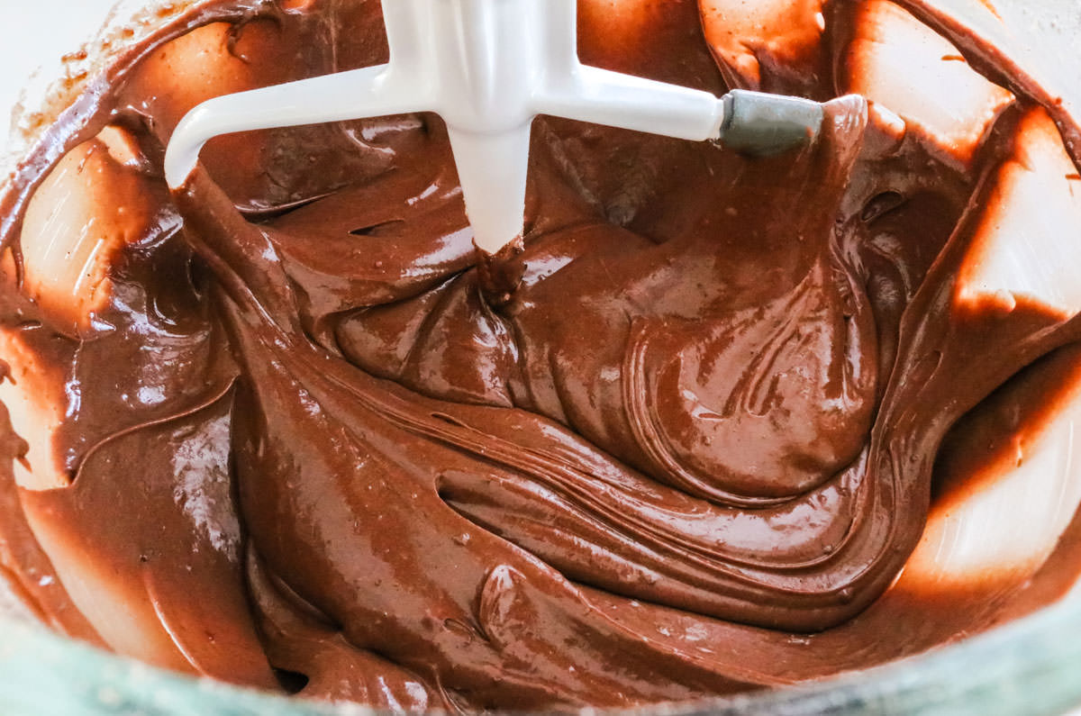 Clear mixing bowl filled with chocolate cake batter.